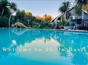 a swimming pool with a dinosaur in the water at 24 On Basil Boutique Luxury hotel in Johannesburg +133 photos