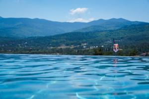 a pool of water with mountains in the background at Katalina Resort in Tsigov Chark
