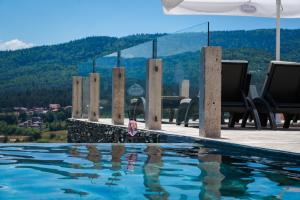 a swimming pool with a view of a mountain at Katalina Resort in Tsigov Chark