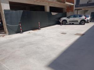 a white car parked in a parking lot at Nexus 3 in Recale