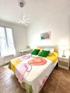a bedroom with a large bed and a ceiling fan at Villa Lila in Nice