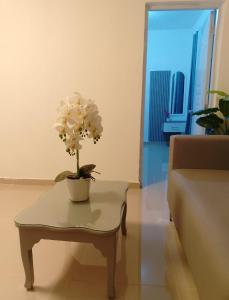 a living room with a table with a flower on it at Boutique Hotel in Pedernales