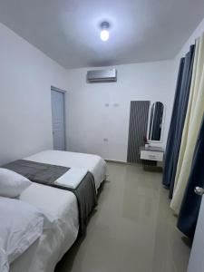 a bedroom with a bed and a tv in it at Boutique Hotel in Pedernales