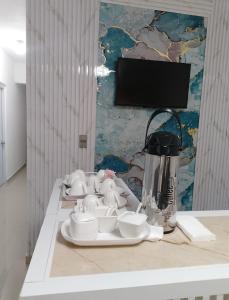 a table with dishes and a blender on it at Boutique Hotel in Pedernales