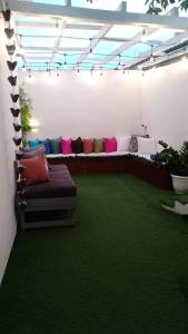 a living room with a couch in a room with grass at Boutique Hotel in Pedernales