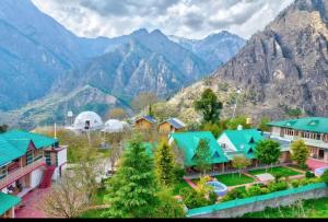 a view of a village with mountains in the background at Regal Retreat in Jari