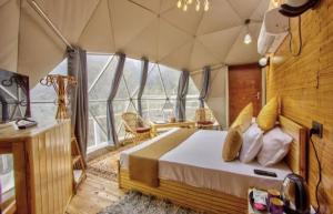 a bedroom with a large bed in a tent at Regal Retreat in Jari