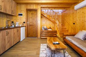 a living room with wooden walls and a staircase at Sinja Park Villas in Sinjë