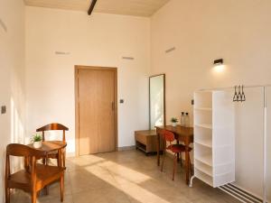 a room with a table and chairs and a dining room at Amrutiya Farm in Bhuj