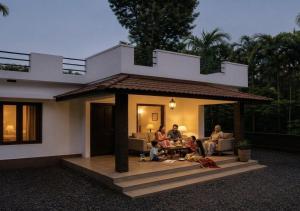 a group of people sitting in front of a house at Casa Horizon in Sultan Bathery