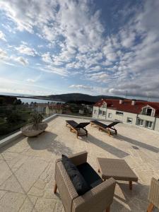 a patio with couches and tables on a roof at O NAUTICO suites in Cabana de Bergantiños