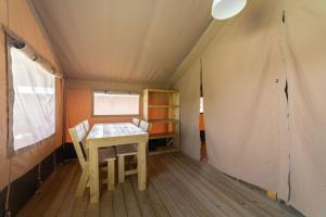 a room with a table and chairs in a tent at Camping de Haas in Wolphaartsdijk +17 photos