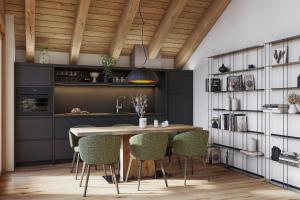 a kitchen with a wooden table and green chairs at Ma Chérie in Livigno