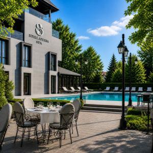 a patio with a table and chairs next to a pool at Stillaterm SPA in Mineralni Bani