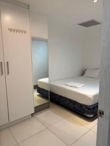 a bedroom with a bed and a mirror at island payless private room in Nadi