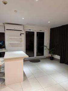 a kitchen with a white counter top in a room at island payless private room in Nadi