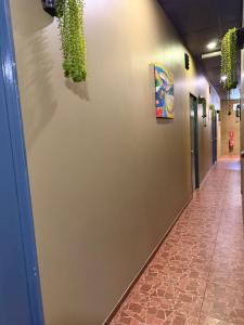 a hallway with a wall with plants on it at Ghazrins Garuda Hotel in Johor Bahru