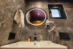 a bathroom with a mirror and a sink at Sinja Park Villas in Sinjë +53 photos
