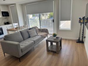 a living room with a couch and a table at Serenity Valley Brooklyn in Brooklyn