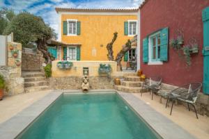 a swimming pool in front of a house at Villa Ochre - Rustic Retreat in Tsilivi