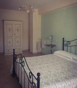 a bedroom with a bed and a dresser in it at Casa Vacanze Il Castello in Pescina