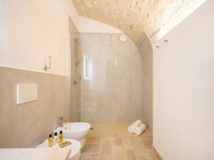 a bathroom with a shower and a toilet and a sink at Palazzo Della Tore 001-Elegant Historic Escape in Torre a Mare +23 photos