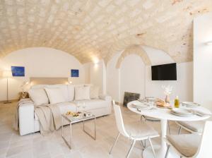 a living room with a white couch and a table at Palazzo Della Tore 001-Elegant Historic Escape in Torre a Mare