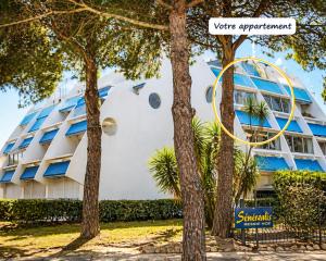 a building with trees in front of it at Bel appart vue lac in La Grande Motte +22 photos