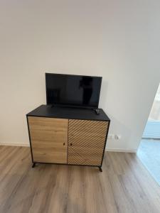 a tv on top of a dresser in a room at LONI Expériences moderne emplacement idéal in Challans