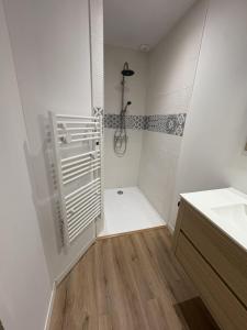 a white bathroom with a shower and a sink at LONI Expériences moderne emplacement idéal in Challans +11 photos