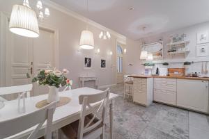 a kitchen with a table and chairs and a dining room at Serenity Boutique Budapest in Budapest