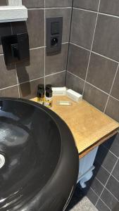 a bathroom with a sink and two wine glasses on a counter at Coquille in Nieuwpoort