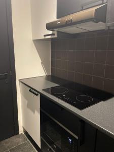 a kitchen with a stove and a counter top at Coquille in Nieuwpoort +5 photos
