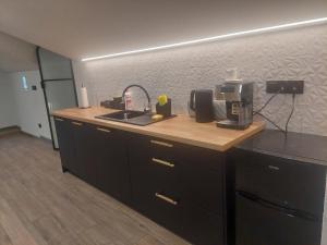 a kitchen with a counter top with a coffee maker and a sink at Pod skosem in Witów