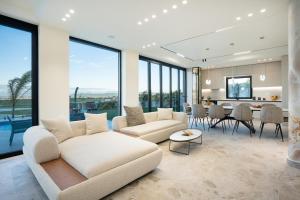 a living room with a white couch and a table at Villa Cosmo Panorama in Rrashbull