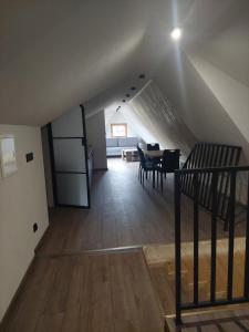 an attic room with a table and a dining room at Pod skosem in Witów