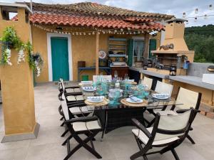 a dining table and chairs on a patio at Villa Ochre - Rustic Retreat in Tsilivi
