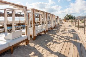 a row of beds lined up on the beach at Luxury Beachfront "Felicità" Sea View 6 Guests in Arenales del Sol
