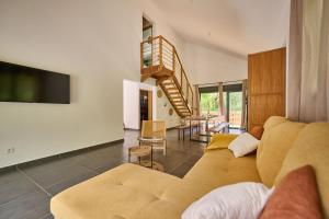 a living room with a couch and a tv at Le Clos des Remparts - 8 pers - Cascades & Nature in La Plaine des Palmistes
