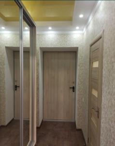 an empty hallway with a door and two windows at ЖК Хмельницький in Dnipro