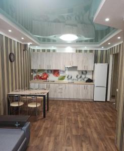 a large kitchen with a table and a refrigerator at ЖК Хмельницький in Dnipro