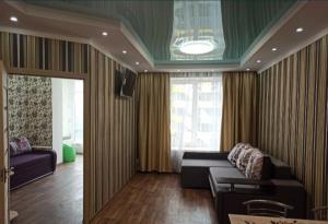 a living room with a couch and a window at ЖК Хмельницький in Dnipro