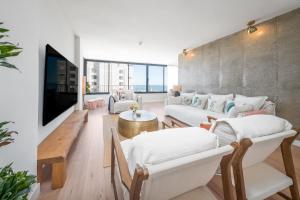a living room with a couch and a tv at Luxury Beachfront "Felicità" Sea View 6 Guests in Arenales del Sol