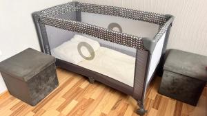a metal bunk bed in a room with a wooden floor at Baltijos 12b Apartamentai in Klaipėda