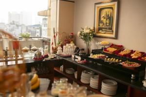 a buffet in a hotel room with food on display at Luxeden Classic Hotel in Hanoi