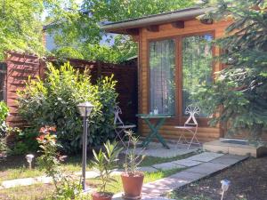 a small wooden cabin with a glass door at Katies Tiny House in Budapest