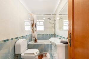 a bathroom with a toilet and a sink at Lisbon Coastal Retreat in Charneca +32 photos