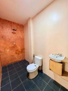 a bathroom with a toilet and a sink at Ayu Homestay - Room 3 in San Isidro