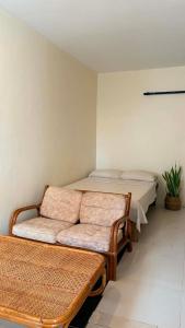 a room with a bed and a couch in it at Ayu Homestay - Room 3 in San Isidro