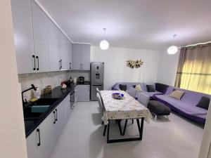 a kitchen and living room with a table and a couch at Luxurious seaside apartment in Sakës